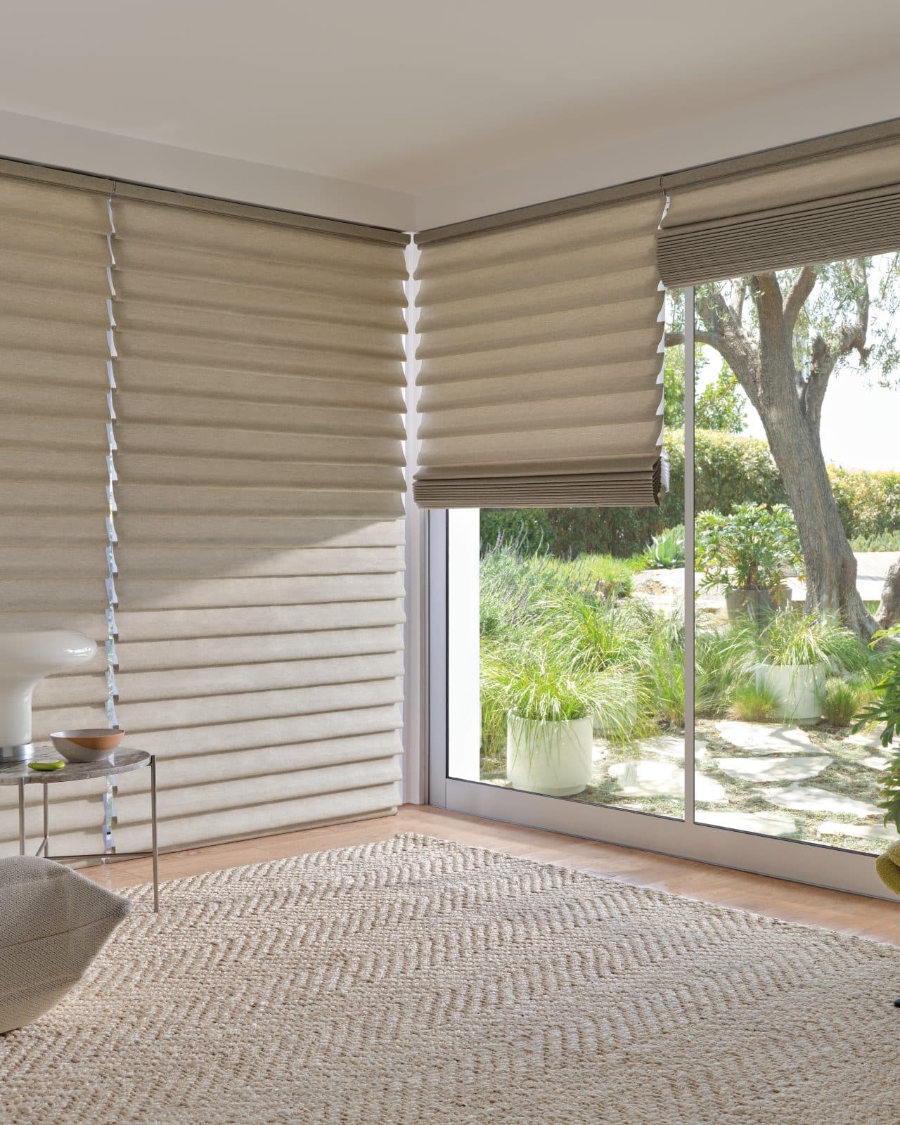 Morning light entering a calm bedroom over automated shades