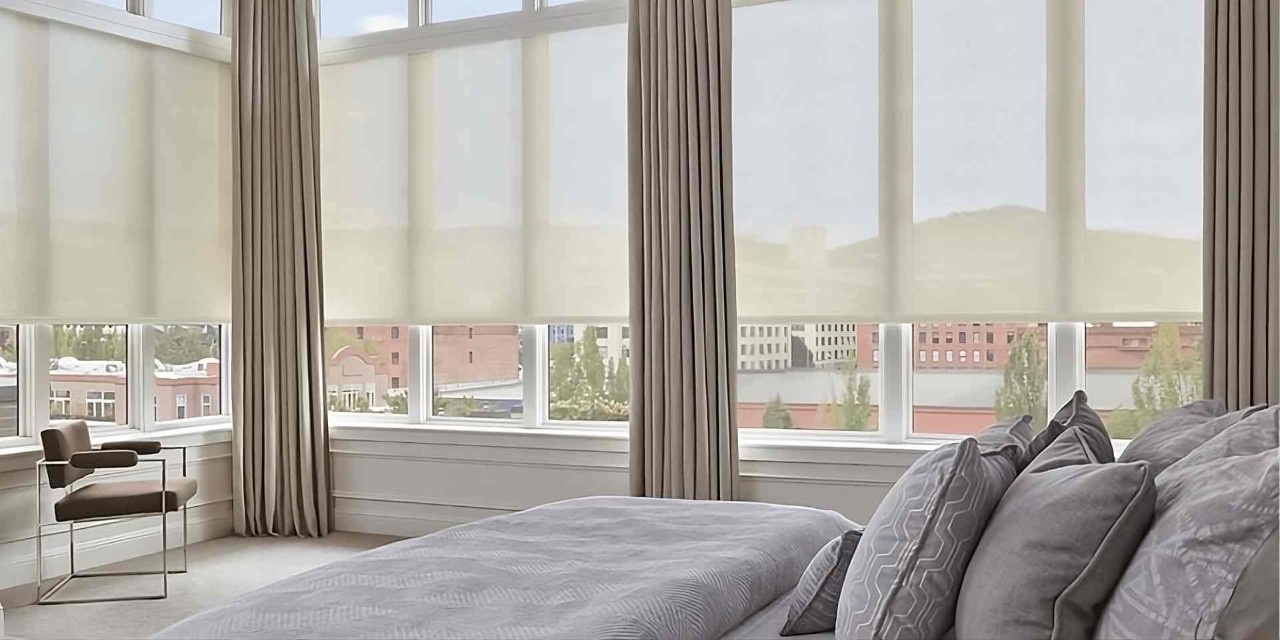Stylish Hunter Douglas Designer Solar Shades on several large windows in a bedroom, paired with drapes at Window Decor of Fairfax near Fairfax, VA
